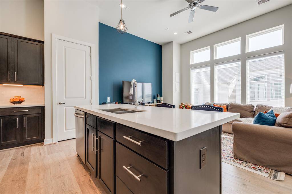 Enjoy entertaining family & friends in this modern kitchen with lots of cabinets, pantry, SS appliances, gorgeous quartz counters &  space for bar stools