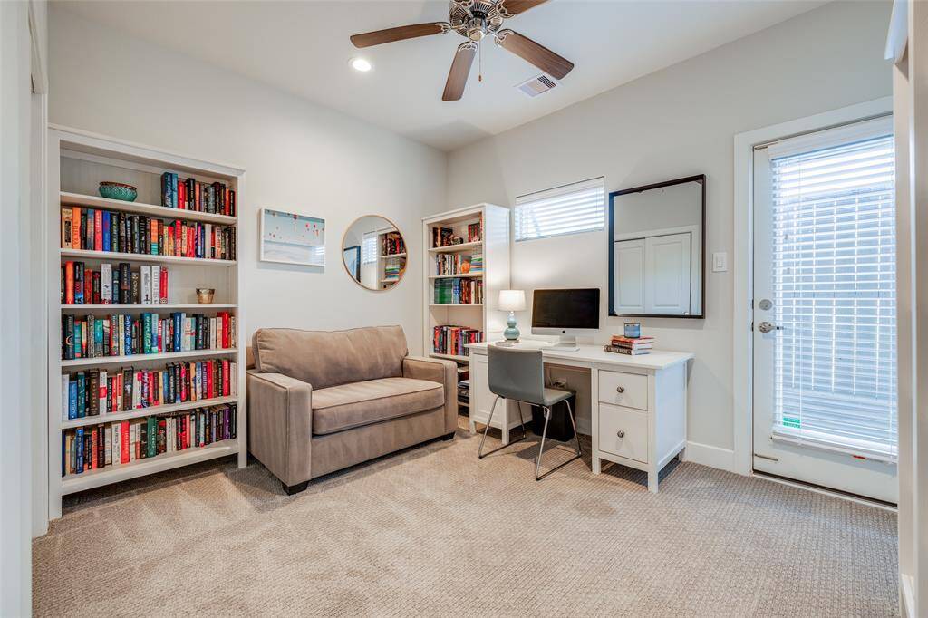 Bedroom 3 on first floor, currently being used as an office, access out to back yard, with access to shared bathroom, ceiling fan, 2 in blinds, carpet, large closet