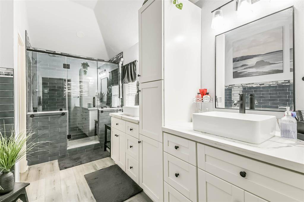 Primary bath with updated shower, cabinets new flooring and double sinks