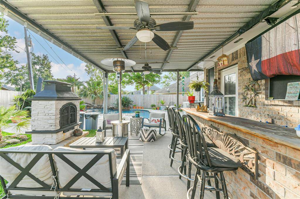 Back covered patio with fireplace and bar