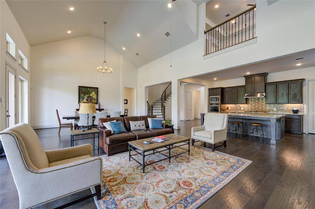 Experience the grandeur of high ceilings highlighting an elegant chandelier and sleek recessed lighting in the family and dining rooms.