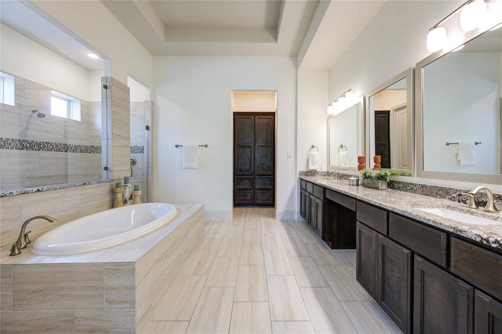 Discover the ample built-in storage in this elegant bathroom.