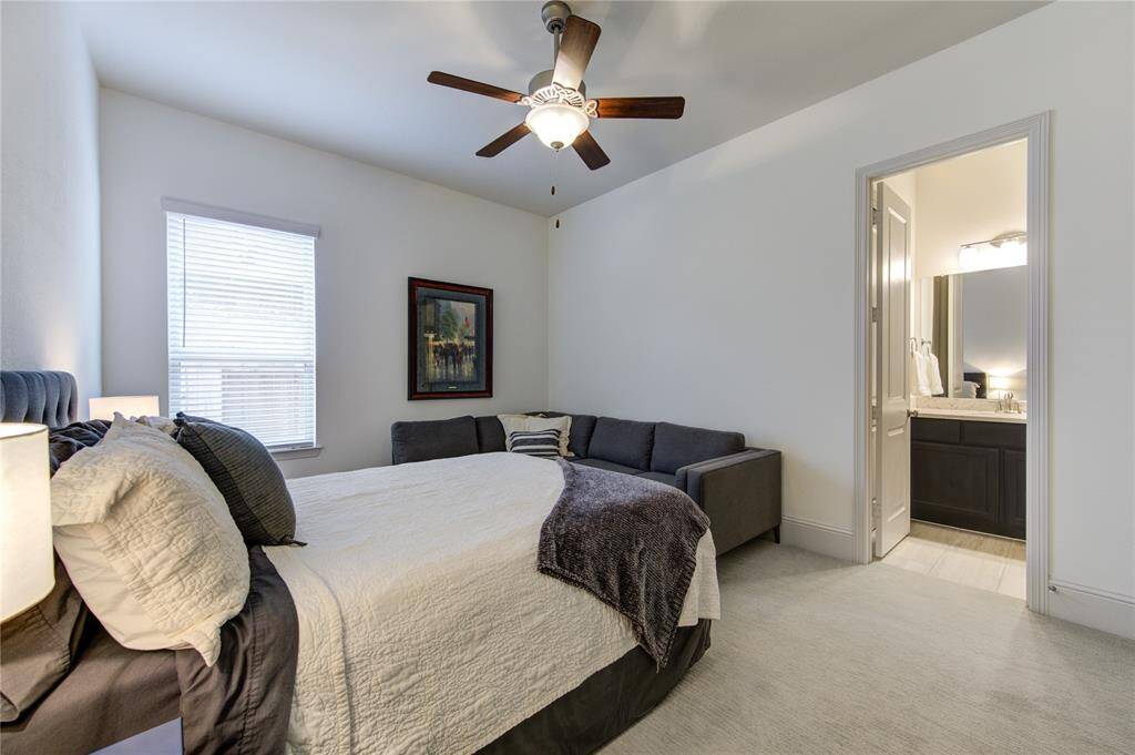 This inviting downstairs bedroom #2 features a ceiling fan and a nice size walk in closet, enough room for a cozy seating area, and an ensuite bathroom.