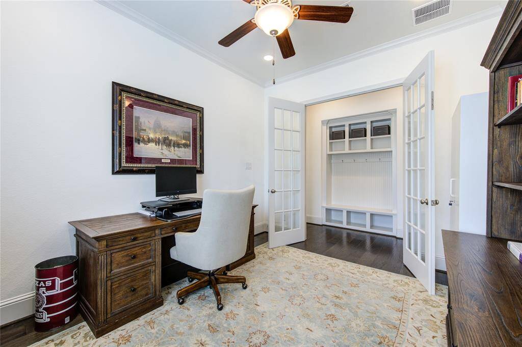 Inviting home office with French doors for privacy, conveniently located off the main entrance.