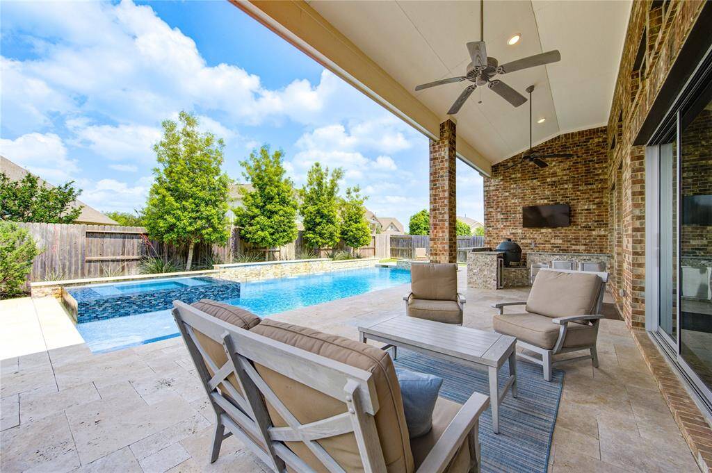 Expansive back patio perfect for lounging and outdoor cooking.