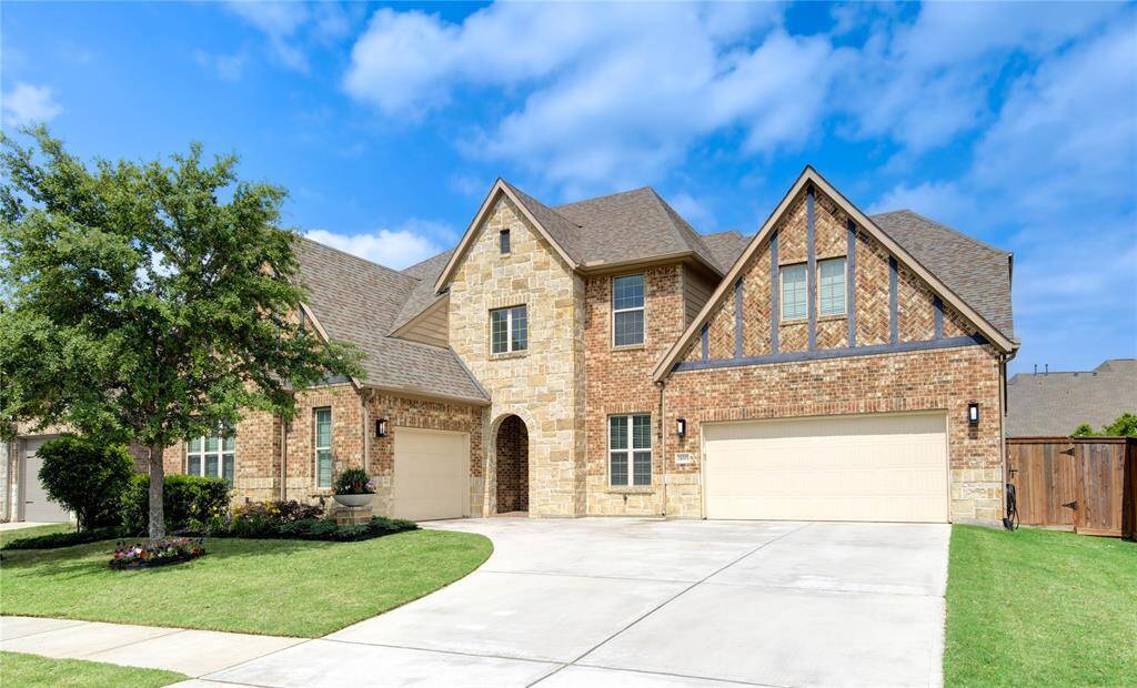 Discover this elegant two-story brick and stone home, featuring a spacious three-car garage. Enjoy privacy with a fenced, well-tended lawn.