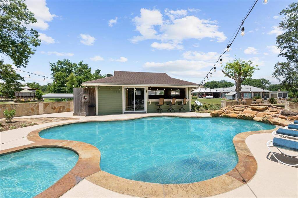 The night lights create a perfect ambiance for evening gatherings and fun by the pool! The pool house includes a full bath for added convenience.