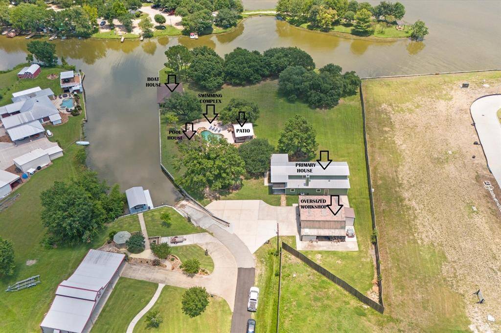 Boat house, pool house, swimming complex, patio, primary house, oversized workshop all on 1.83 acres!