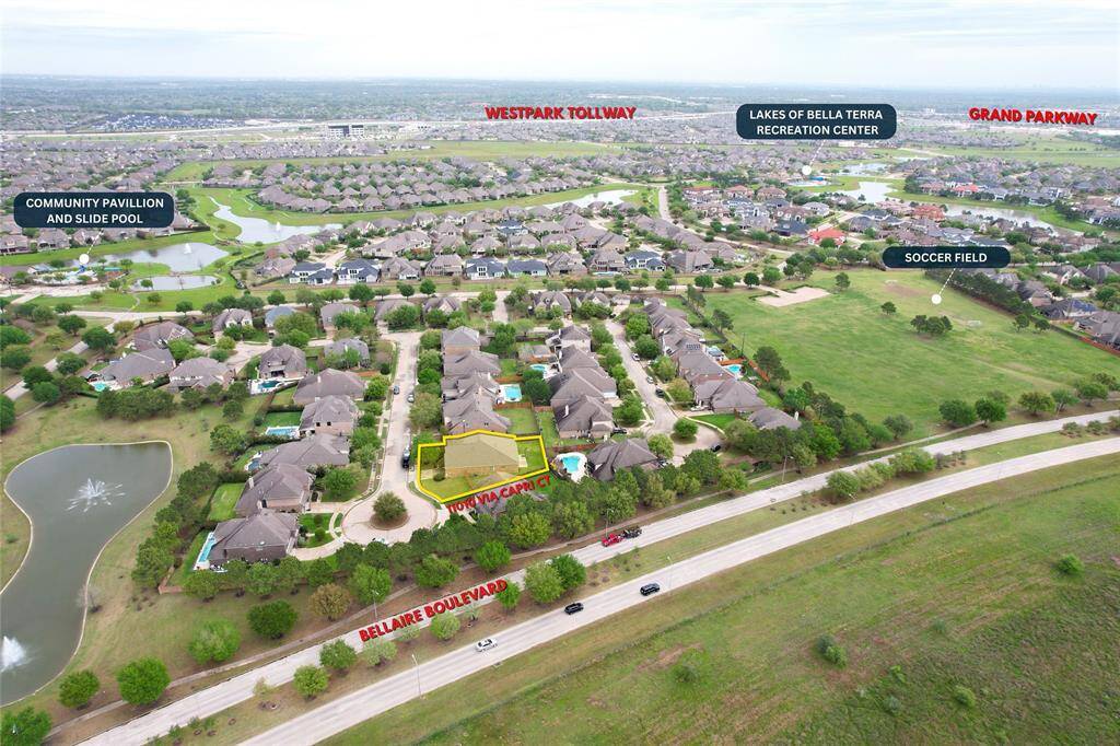 Gorgeous brick and natural stone elevation with a spacious 3-car garage and lush landscaping