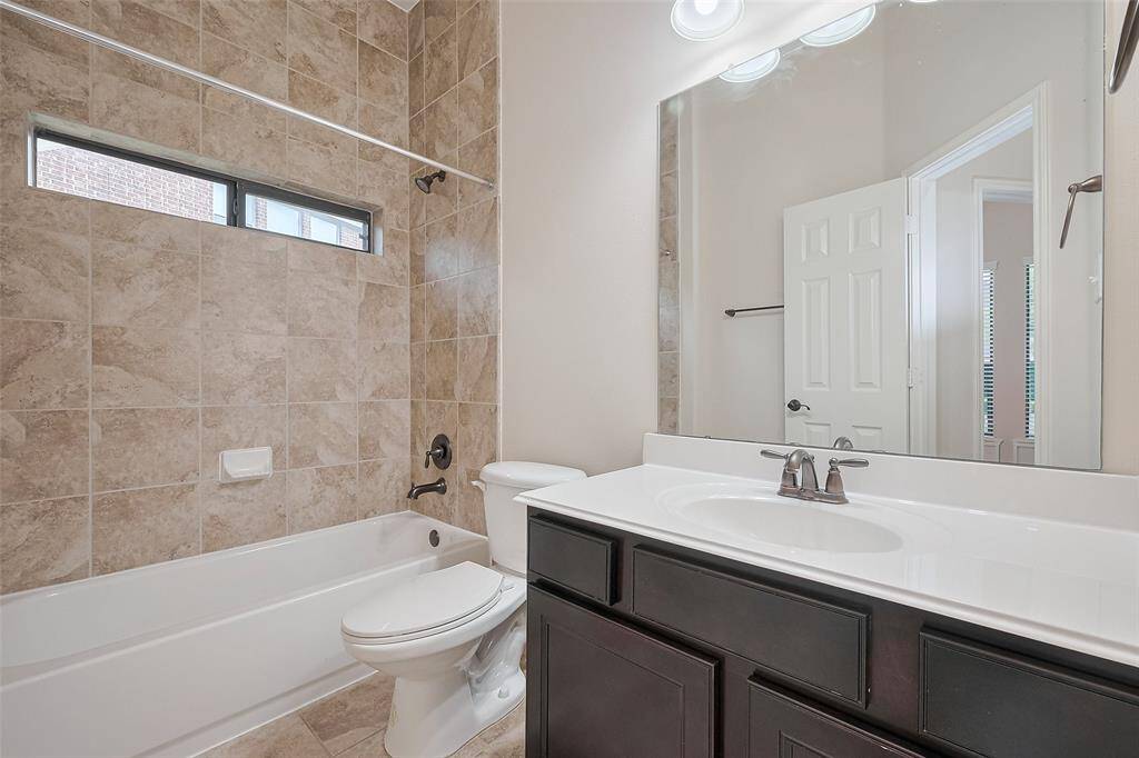 Elegant full bath with updated fixtures and sleek vanity