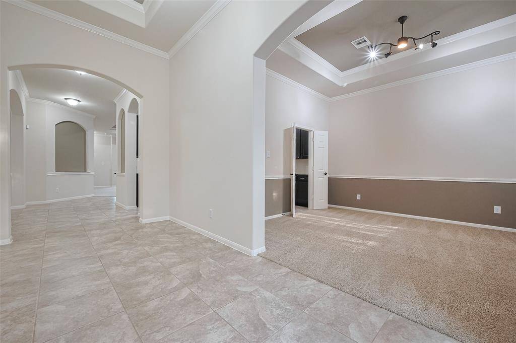 Elegant entryway with coffered ceilings, crown moulding and arched entries