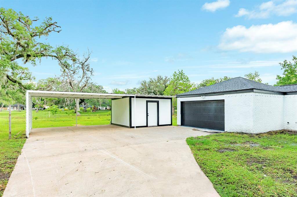 Double garage attached. Carport and additional storage building detached.