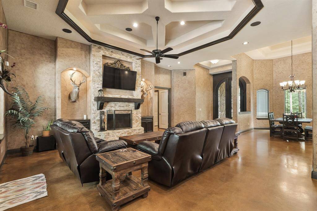Chic family room seamlessly leads to an elegant formal dining area, creating a welcoming space for entertaining.