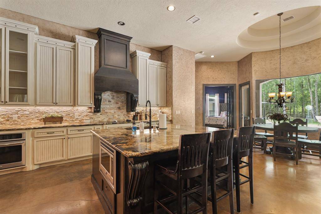 Experience seamless living with this kitchen's open layout connecting to the breakfast area and living room.