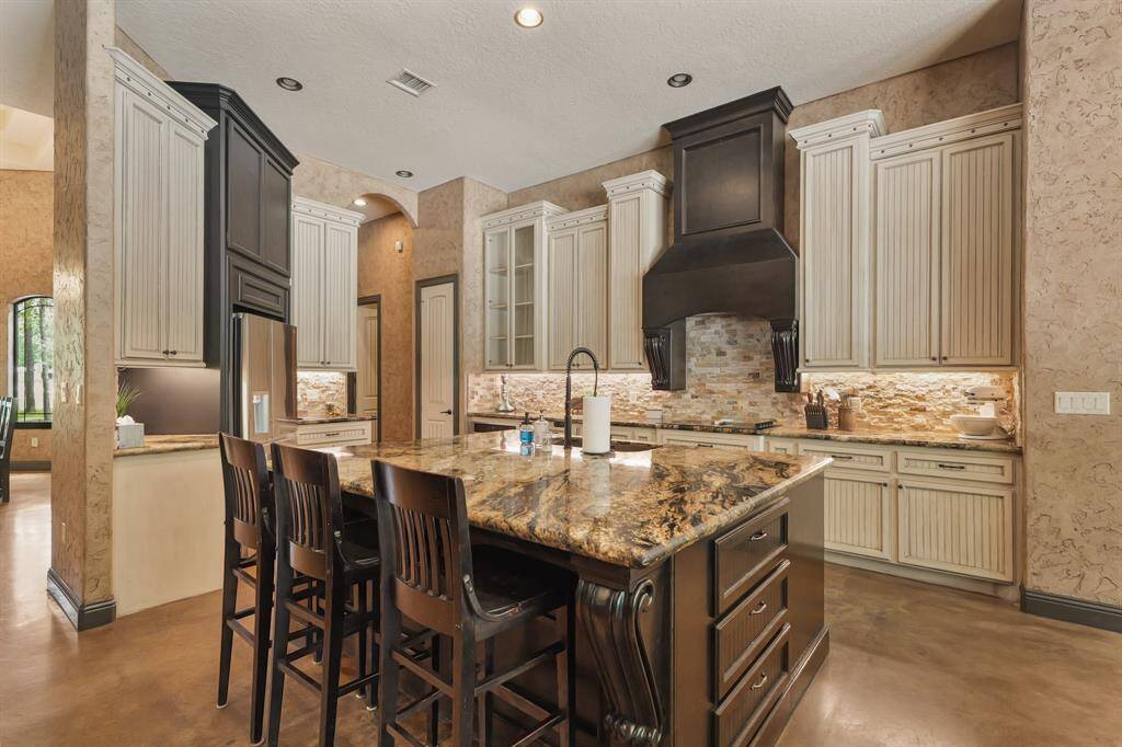Luxurious kitchen with elegant cabinetry, granite countertops, and a spacious island perfect for entertaining.
