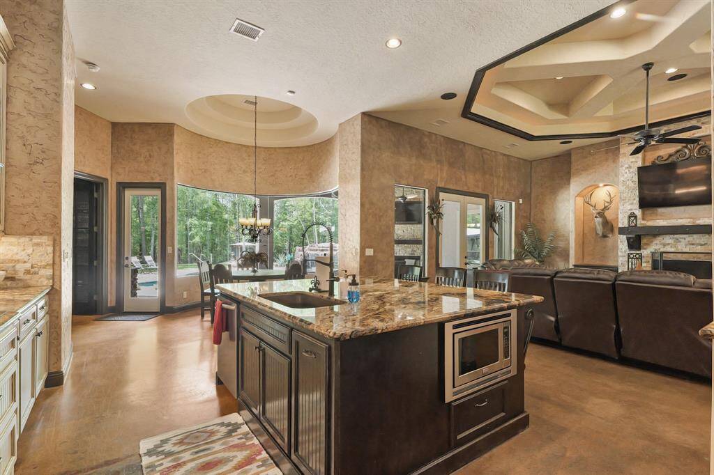 This elegant island features a convenient sink and built-in microwave, perfect for modern living and entertaining.