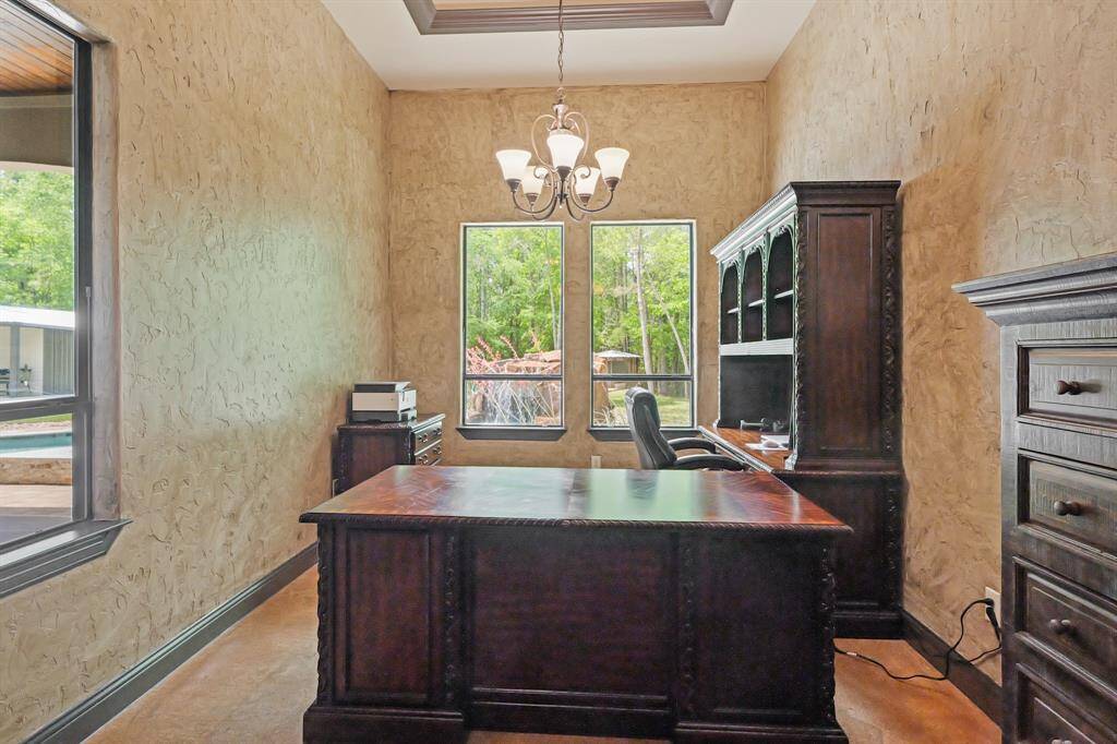 Luxurious primary suite with a versatile sitting area, offering stunning views of the pool.