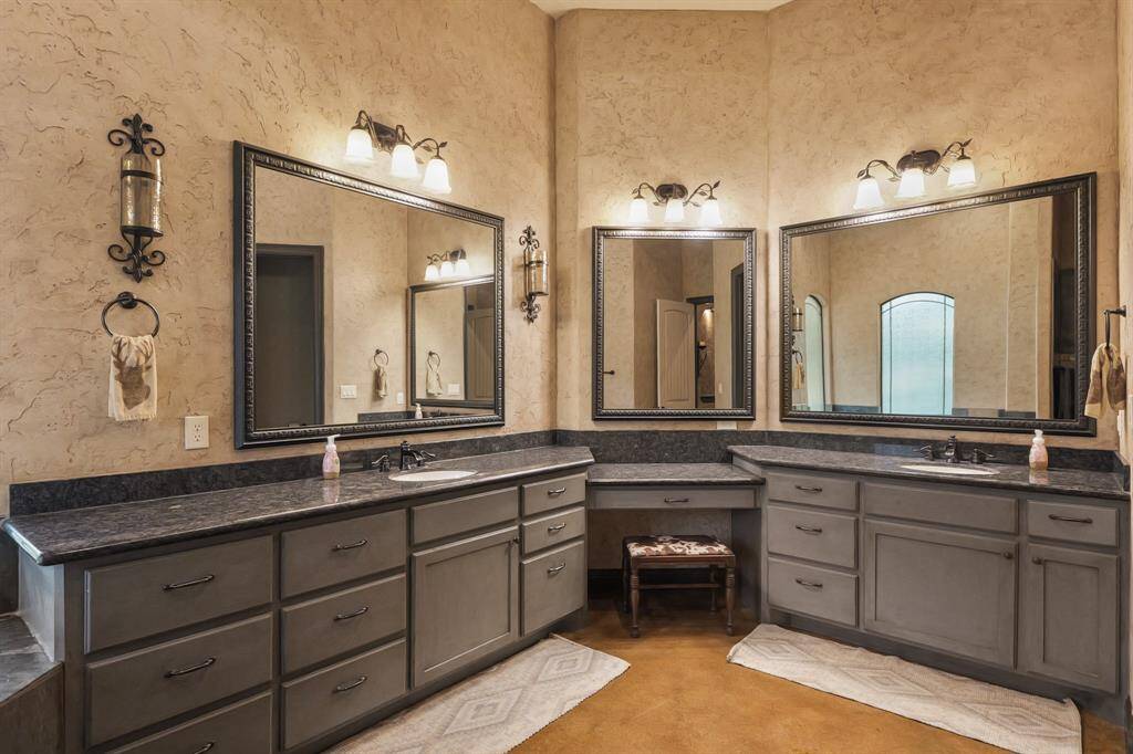 Elegant dual-sink vanity with soaring ceilings.