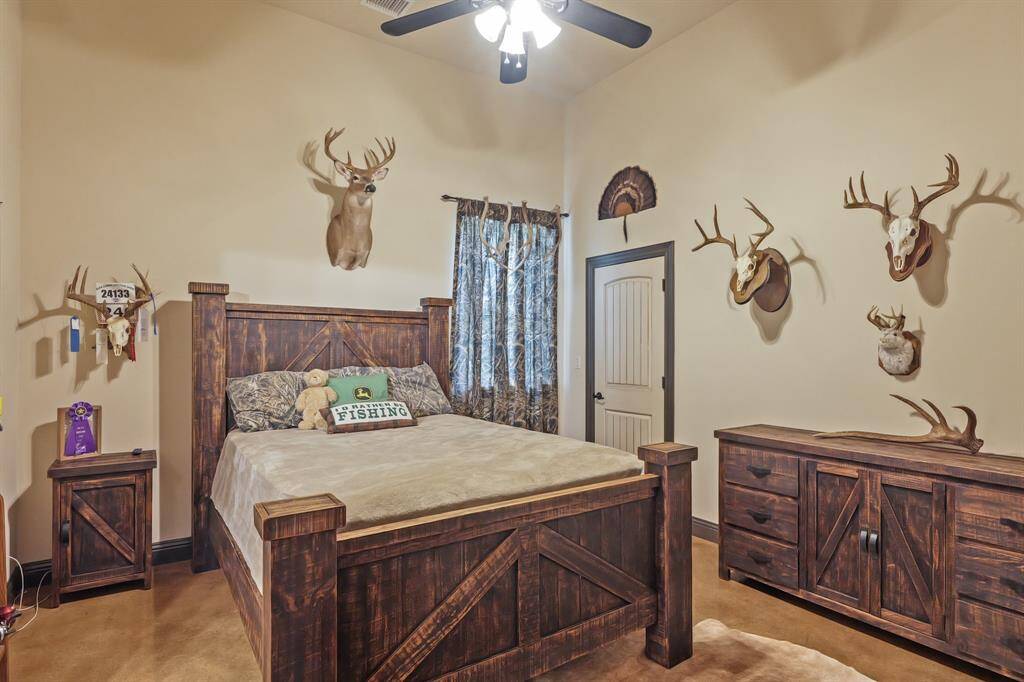 Cozy second bedroom featuring rustic wooden furnishings and unique wall decor, perfect for a serene retreat.