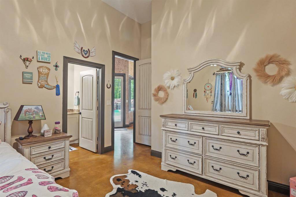 Charming fourth bedroom with elegant decor and access to a serene outdoor view.