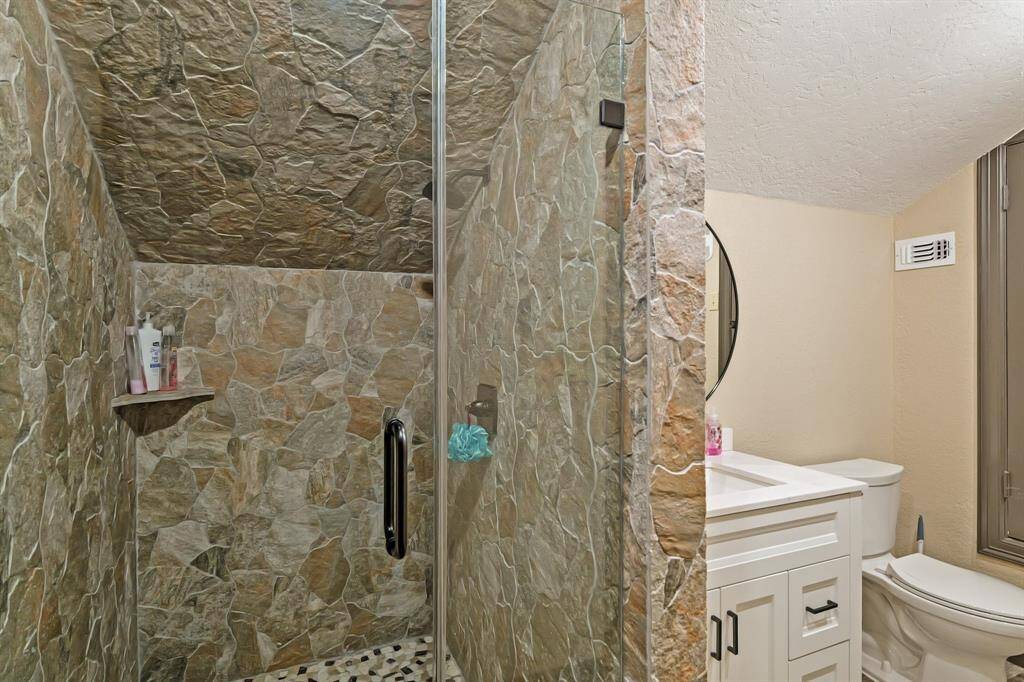 Enjoy the convenience of a private bathroom with a standup shower, seamlessly connected to the versatile gameroom or 5th bedroom on the second level.