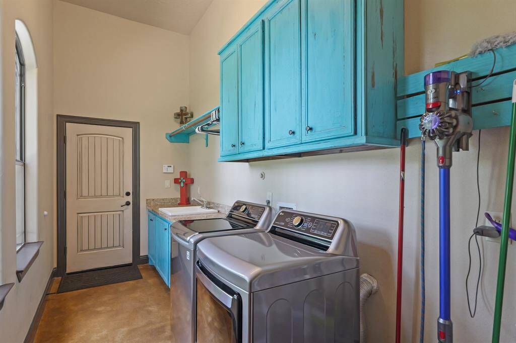 Expansive laundry room with modern appliances and ample storage.