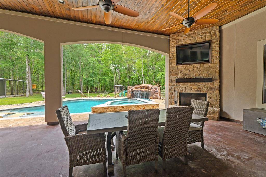 Cozy outdoor oasis with a wood-burning fireplace and TV included.