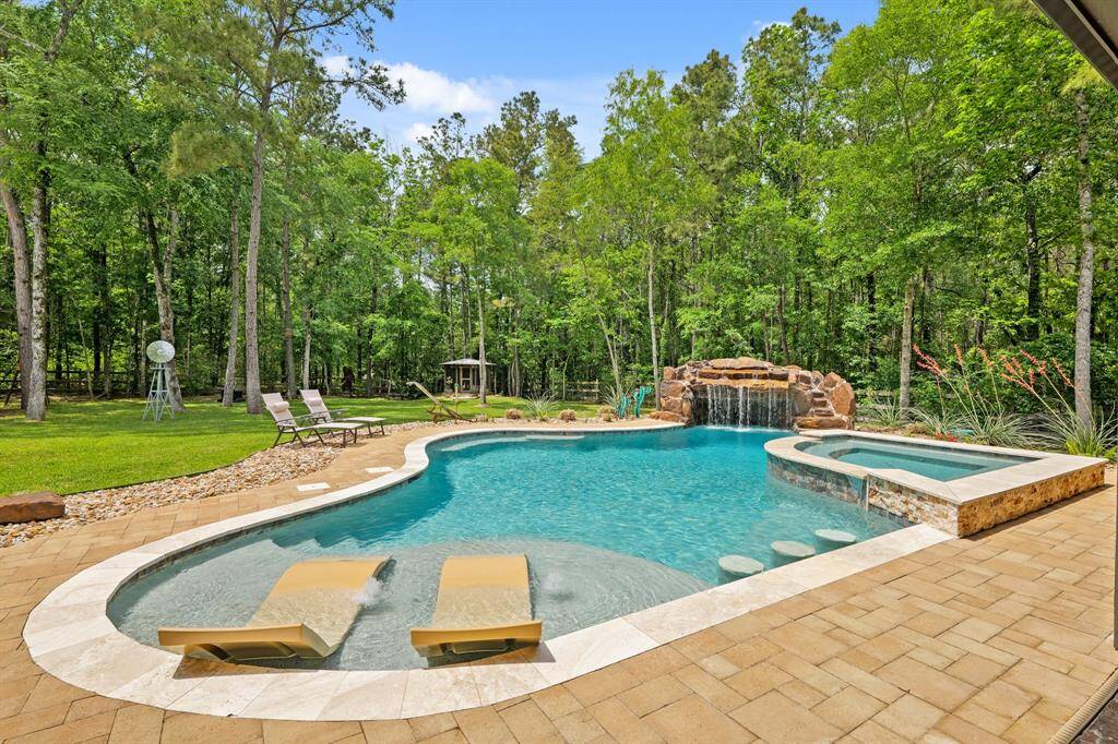 Dive into luxury with a heated pool featuring a stunning grotto and diving rock.