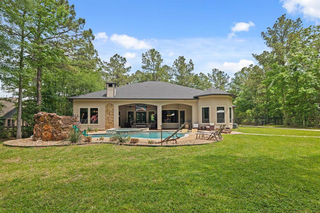 Experience serene outdoor living with this home's inviting backyard, featuring a lush lawn, spacious patio, and sparkling pool.