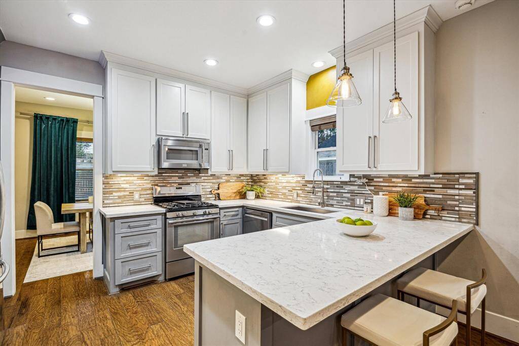 The kitchen features under cabinet lighting, quartz countertops, stainless steel appliances, and accent lighting to create any atmosphere you want!