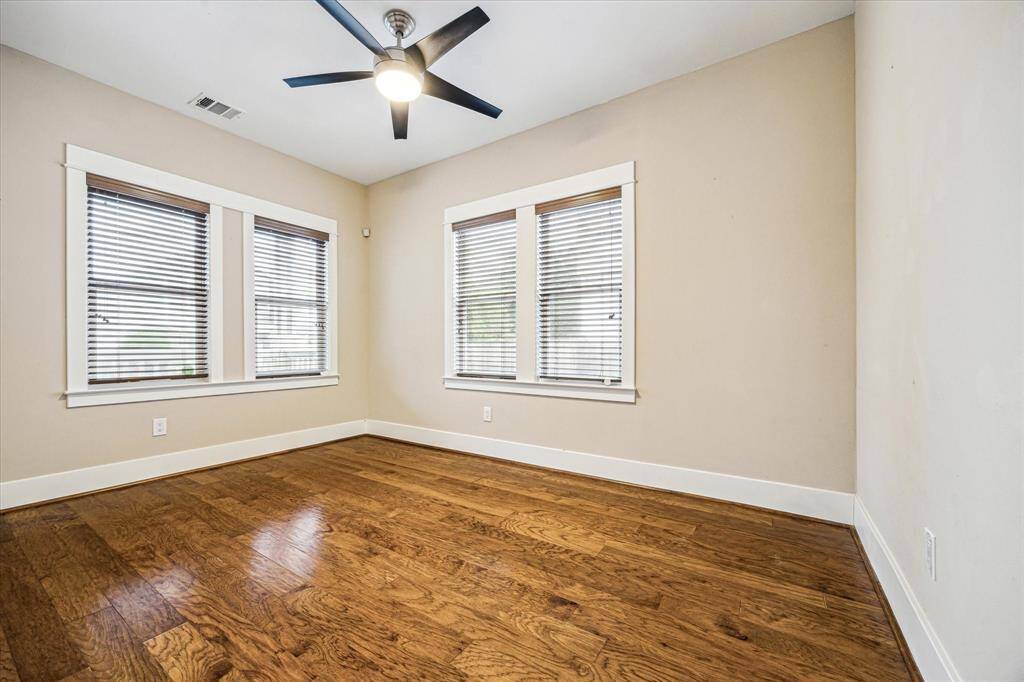 This first floor room is considered a flex space andwas previously used as both a guest room and office. There is an under stair closet in this room for added storage if it's used as the fifth bedroom.There are hardwood floors throughout and a ceiling fan is in every room.