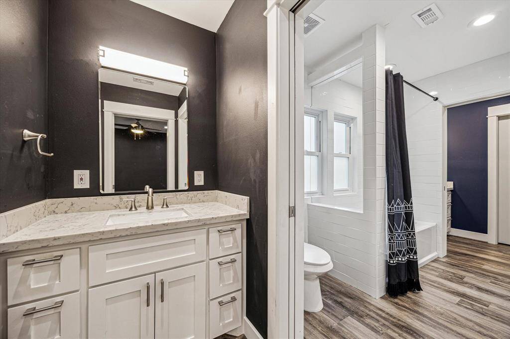 Pocket doors separate the two vanities in the Jack and Jill bathroom. Each side gets their own vanity and sink.