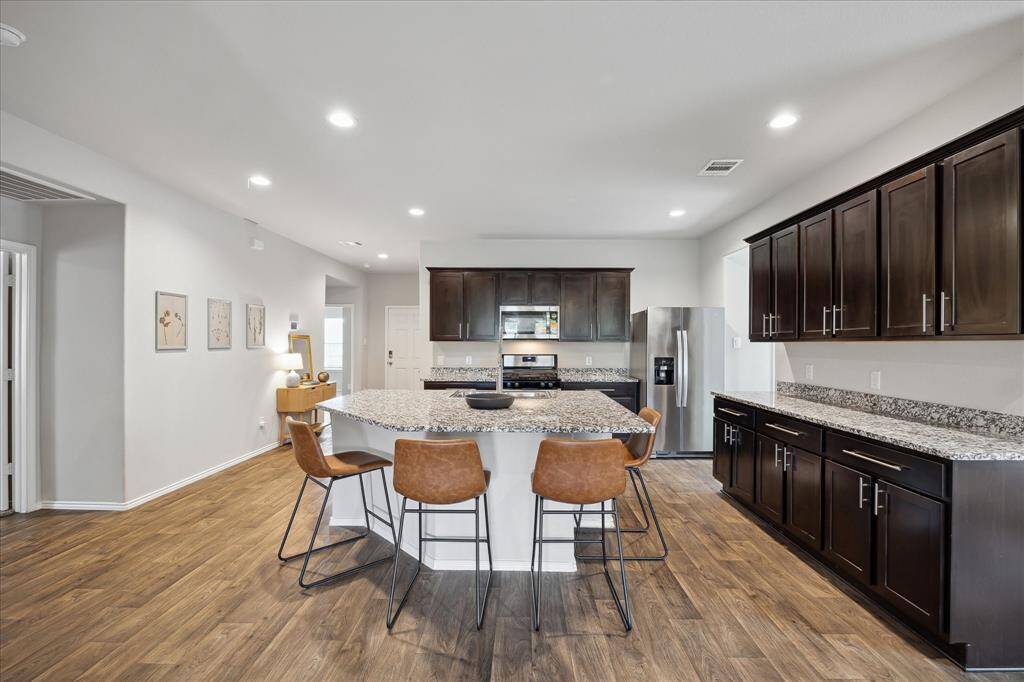 Another view of the kitchen with more counter space and cabinets than you could imagine! And this island is even larger in person! Perfect for hosting friends and family!