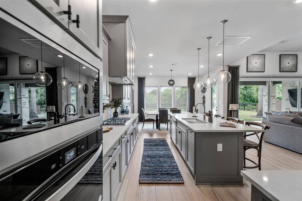 The kitchen is impressively spacious, designed with both functionality and style in mind. It features ample counter space and generous cabinetry. A hidden gem, the walk-in pantry offers additional storage and prep space, making entertaining seamless and keeping the kitchen beautifully organized.