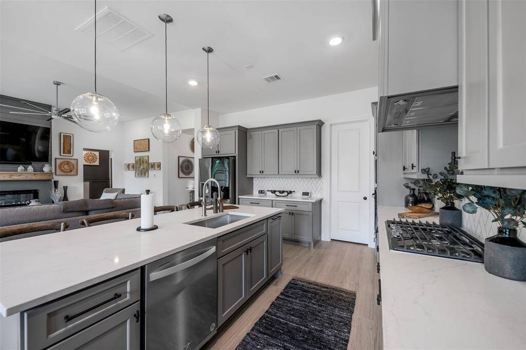The open layout of the kitchen flowing seamlessly into the living and dining rooms is a true bonus, creating a bright, connected space that’s perfect for entertaining and everyday living. Whether you're hosting guests or enjoying a quiet night in, the openness keeps everyone connected and enhances the home's welcoming, airy feel.
