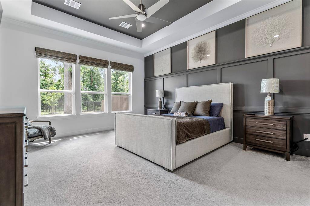 The primary suite is a true oasis, featuring a large window that fills the room with natural light and frames peaceful views. Custom millwork adds a touch of elegance and character, while the spacious ensuite bath offers a spa-like retreat with modern finishes and thoughtful design for ultimate comfort and relaxation.