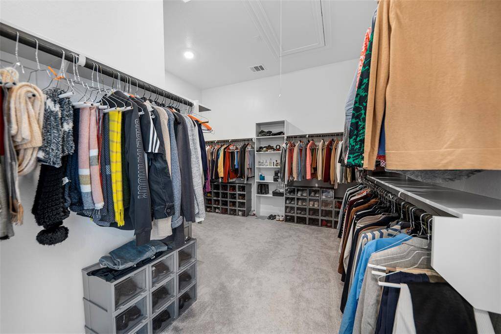 The primary bath boasts a large, wrap-around closet designed to impress. With abundant hanging space, built-in shelving, and room to spare, it offers both luxury and functionality—making organization effortless and stylish.
