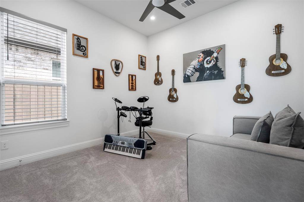 The third bedroom offers a peaceful retreat with its soft color palette that creates a soothing atmosphere. A ceiling fan adds comfort, while the ample closet space ensures plenty of room for storage, making it both functional and inviting.