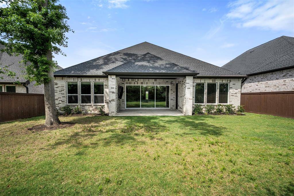 The large backyard offers ultimate privacy, with no back neighbors and backing up to a serene wooded area. The beautiful wrought iron fence adds both elegance and security, enhancing the natural beauty of the space and creating a peaceful retreat for outdoor activities and relaxation.