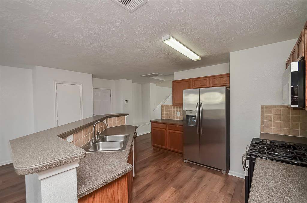 The kitchen boasts a huge island with breakfast bar seating, accompanied by plenty of cabinets and counter space. The layout is truly amazing, offering an abundance of room for cooking and entertaining.