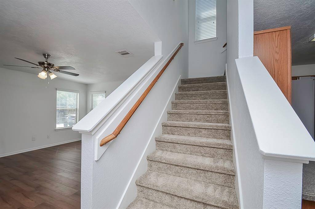 The staircase leads to the second level, where you'll find three bedrooms, two bathrooms, a game room, and a laundry room.