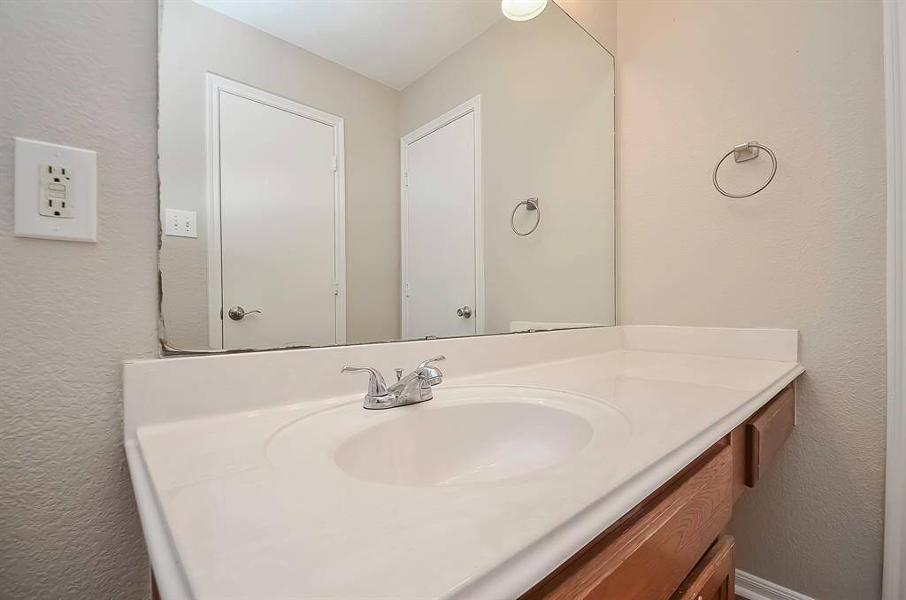 The primary bathroom suite features a vanity with dual prep sinks, providing ample countertop space for your convenience. Enhanced by great lighting and cabinets for storage, it offers both functionality and style. Additionally, you'll find linen closets for added organization.