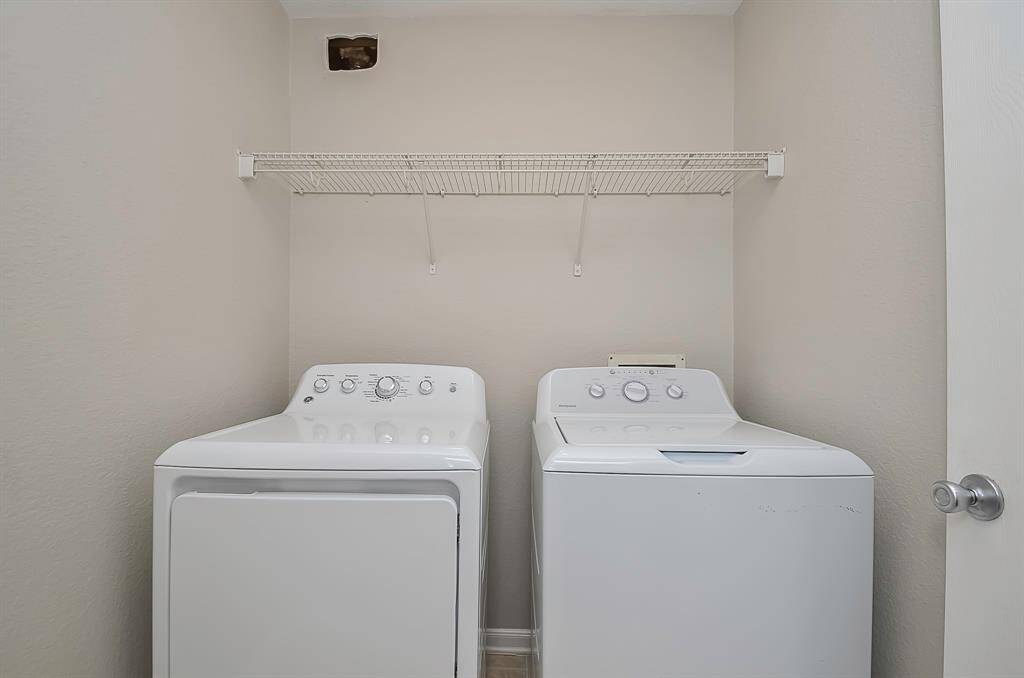 Large Utility room conveniently located upstairs. Plenty room for extra storage includes built-in shelving and cabinetry.