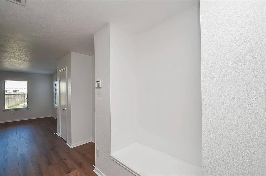 From the living room to the kitchen, you'll find the garage to the right. Take note of the nook for extra storage or a convenient seating bench – perfect for a mudroom setup.