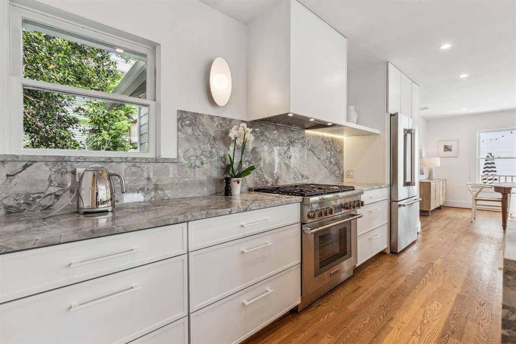 The fleet of upscale stainless steel appliances also includes a vented Thermador six-burner gas range and a French door refrigerator.