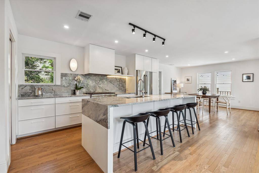 Custom made wood cabinetry throughout the kitchen and pantries includes push-to-open, soft-close doors and drawers, under-cabinet lighting and high-end Schaub hardware.