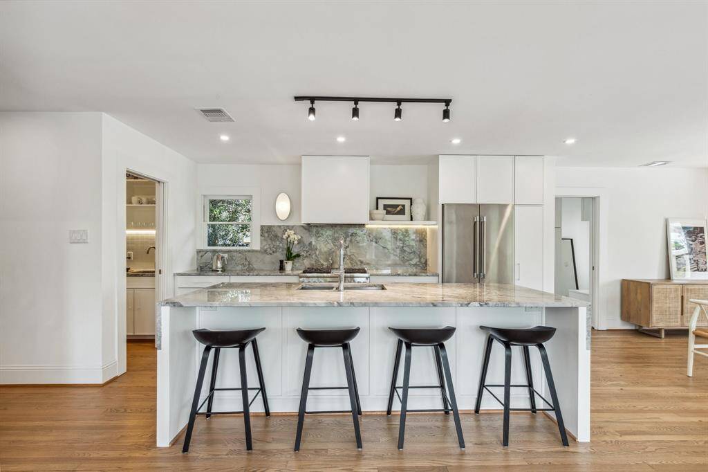 The beautiful center island/breakfast bar provides a wonderful space for meal prep and casual dining for four.