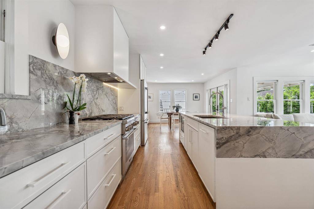 Super White Calacatta Dolomite counters and backsplashes create a consistent, stylish design statement throughout the multiple pantries and work-of-art gourmet kitchen that was completed in 2024.