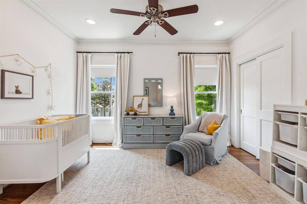 The secondary suite's private bathroom delivers generous counter and cabinet space with a handsome double vanity topped with contemporary black sconces and mirrors.