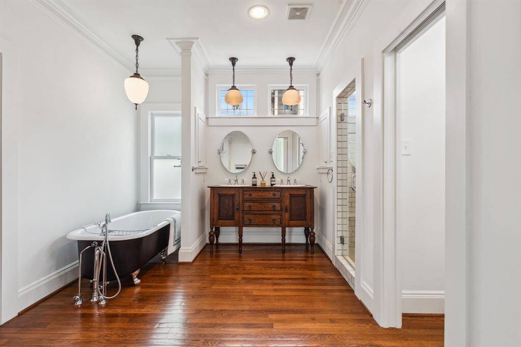 Directly across from the hall bathroom, this secondary bedroom boasts a large closet, double crown molding, ceiling fan and custom blinds. This room fits a queen bed.